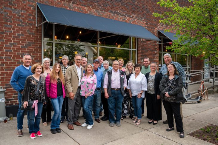 Group of alumni standing outside West Sixth Brewing