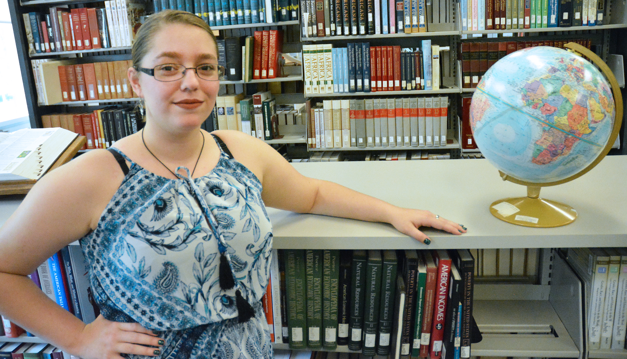 Culp in the library near a globe