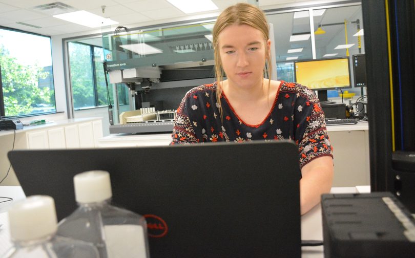 Harper Zeitz, working at a computer in a lab