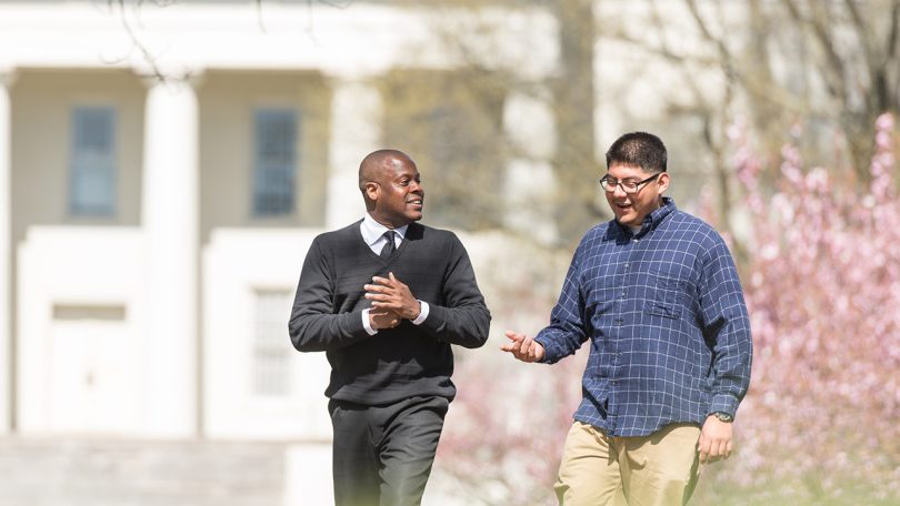 Two men walking on campus