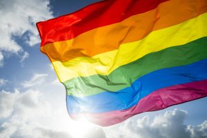 rainbow flag set against blue sky 