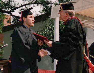 Paul Kim receiving his diploma in 2001