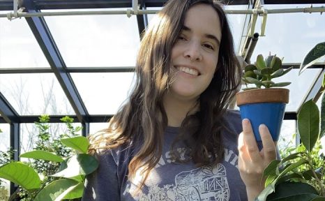 woman holding a plant