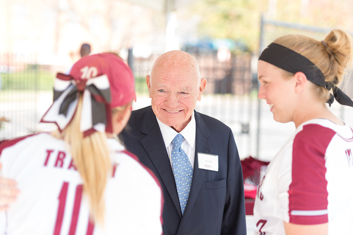 man talking to softball players