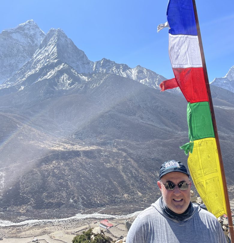 man standing in front of a mountain