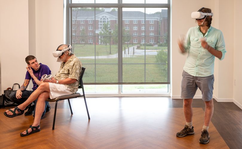 people in a room wearing VR headsets