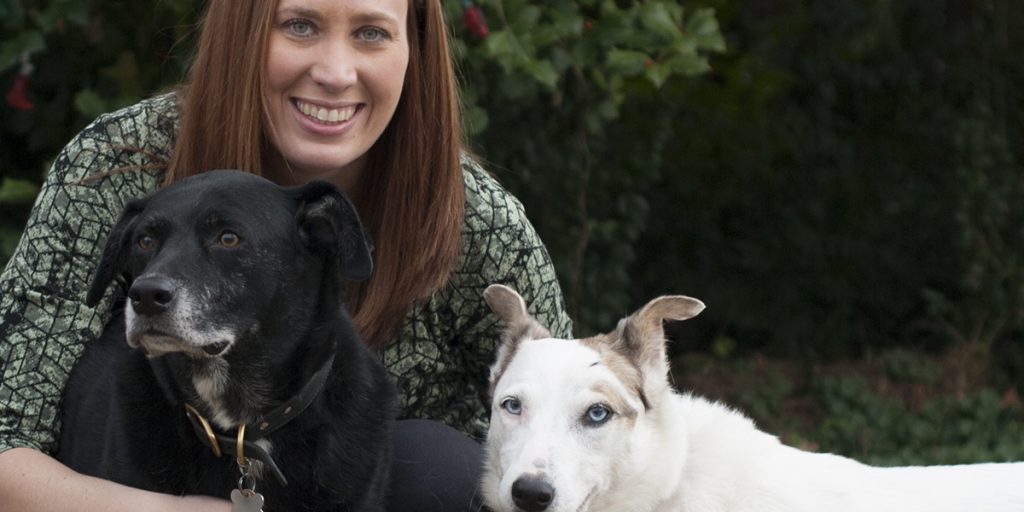 woman posing with dogs