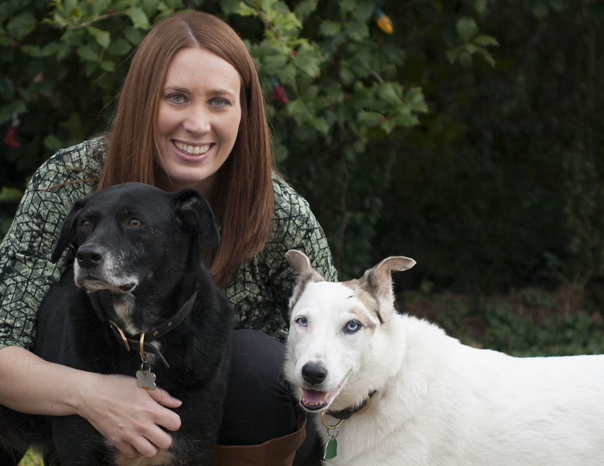 woman posing with dogs