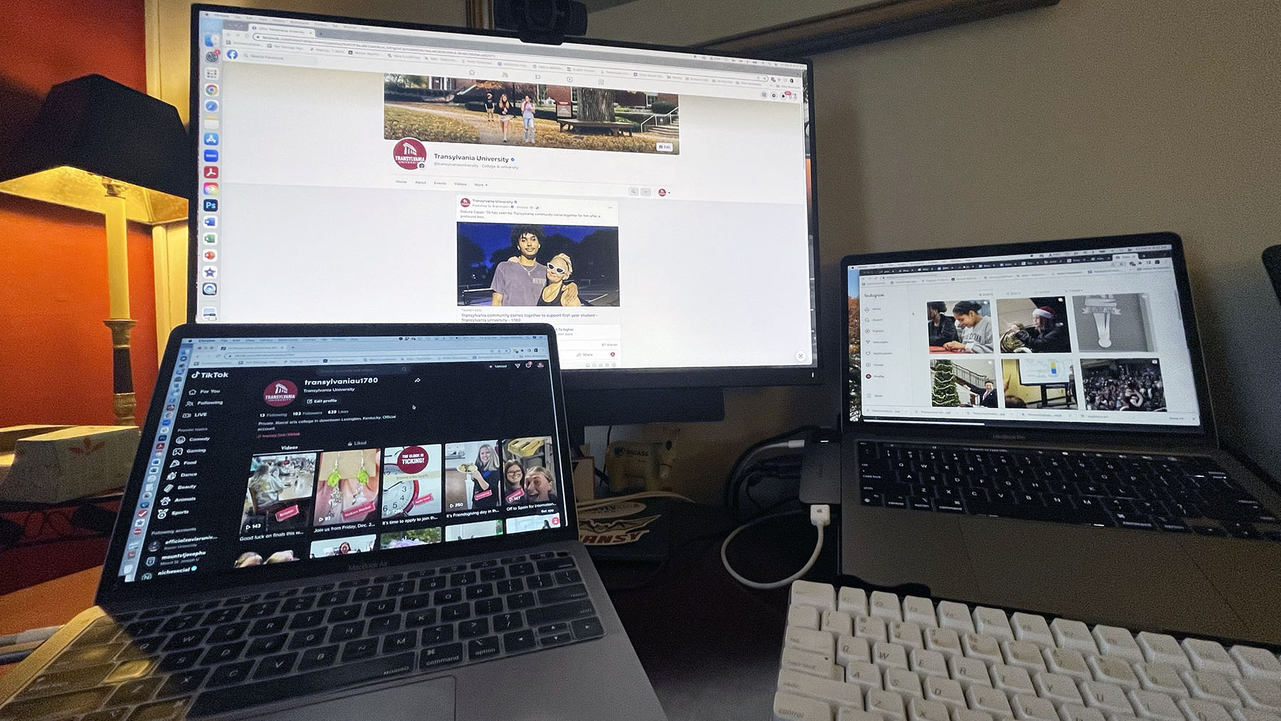 An image of three computers displaying social media sites.