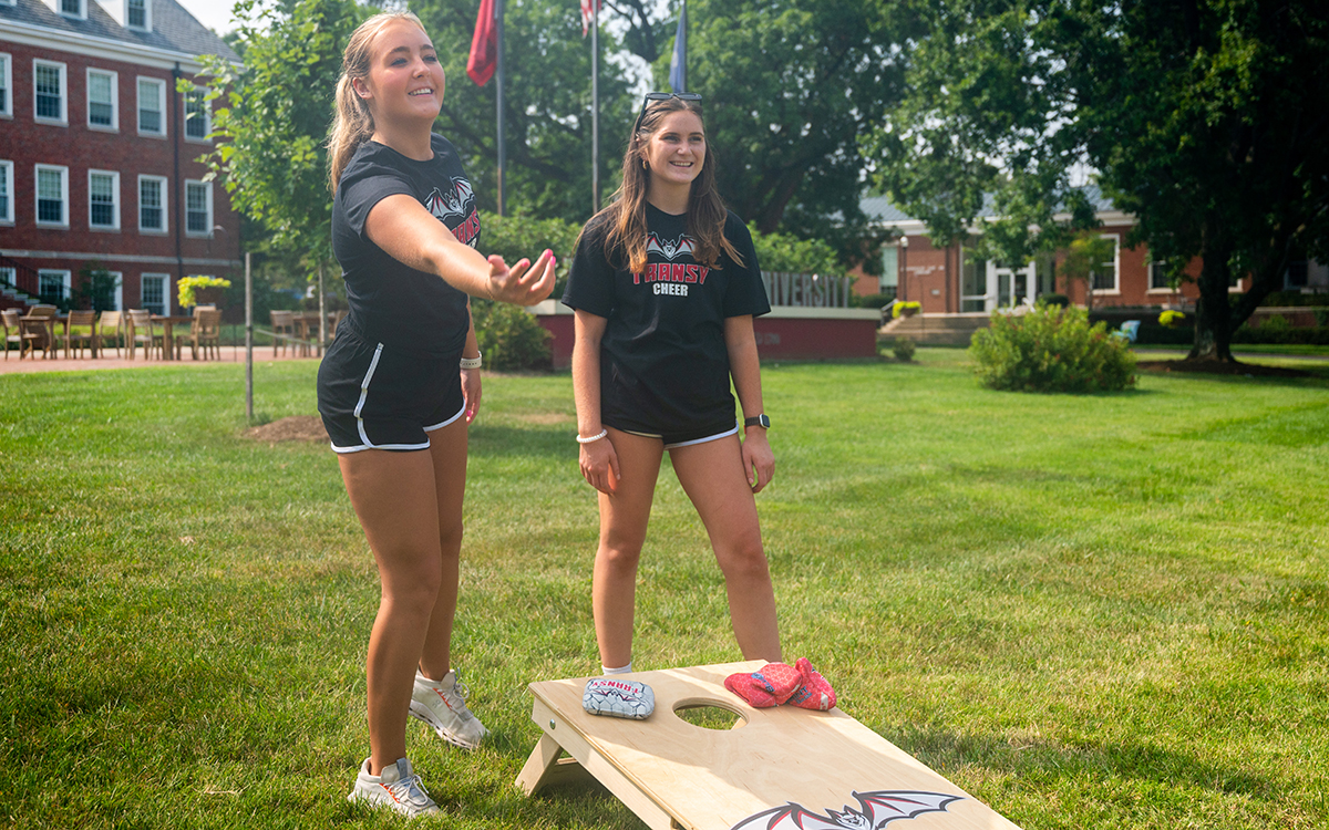 students playing cornhole