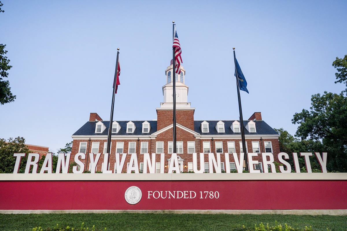 campus sign, flags and building