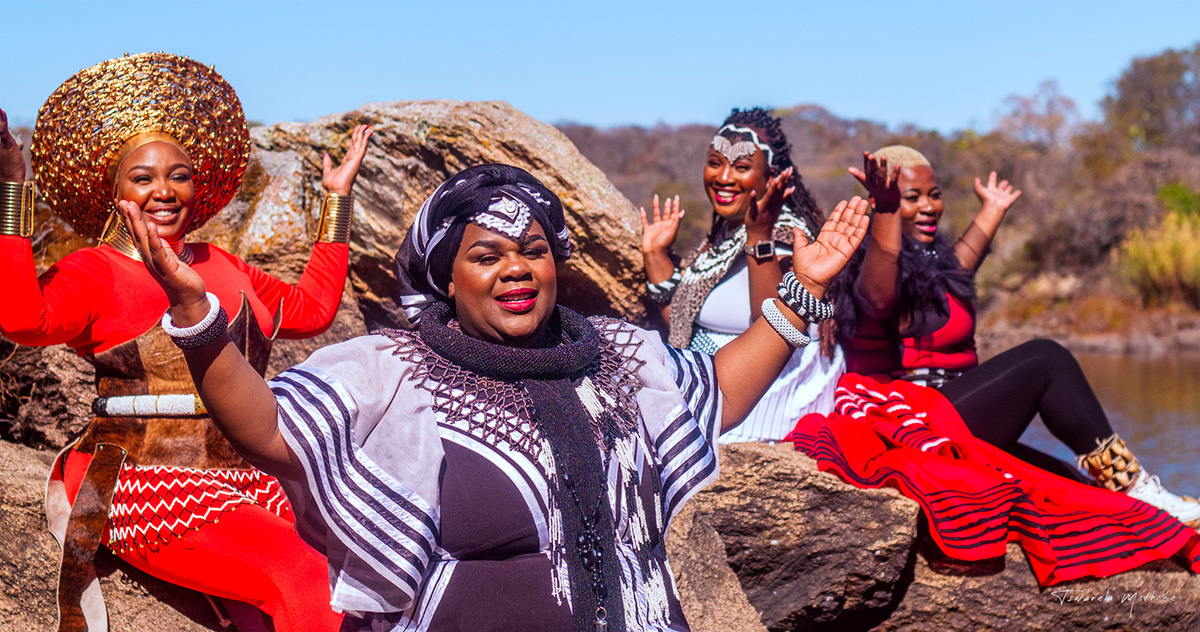 four women with raised hands