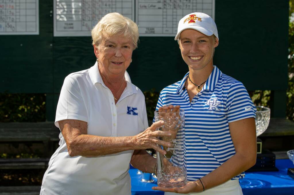 two people holding a trophy