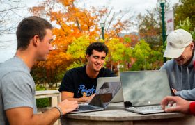 Students in Alumni Plaza on their laptops