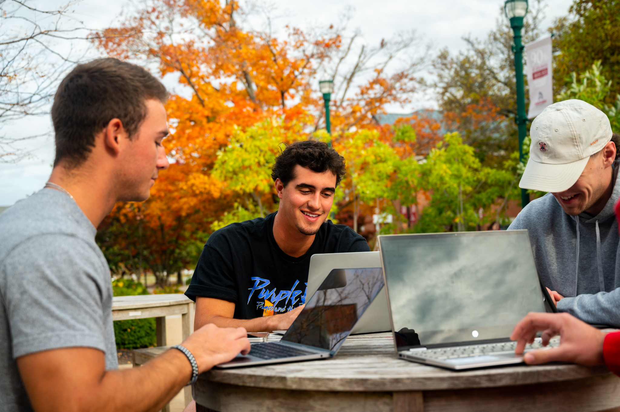 Students in Alumni Plaza on their laptops