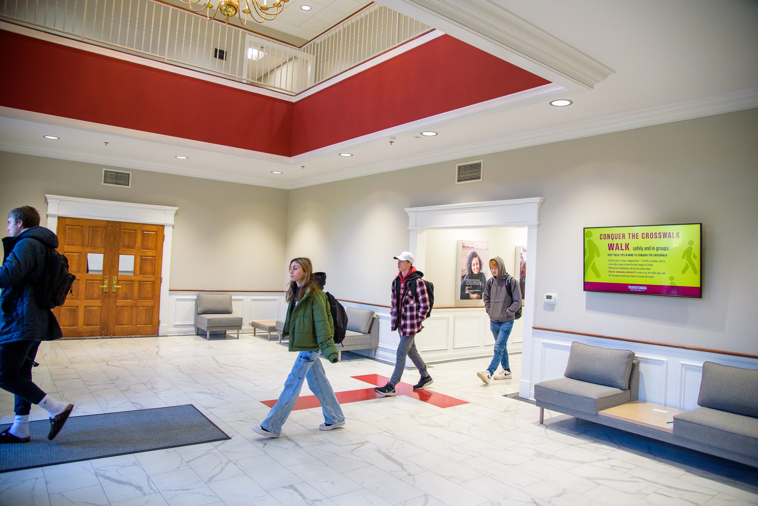 Students walking through the renovated lobby of the Cowgill Center