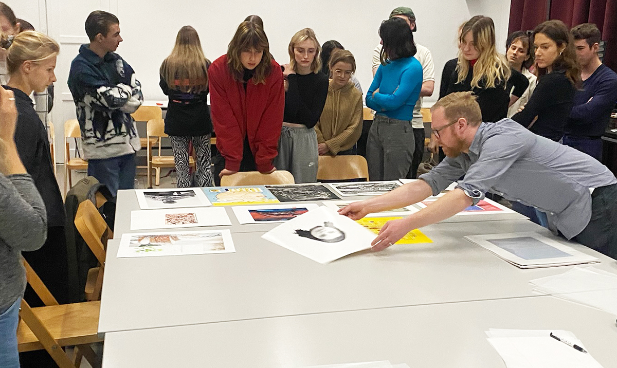 people looking at art on a table