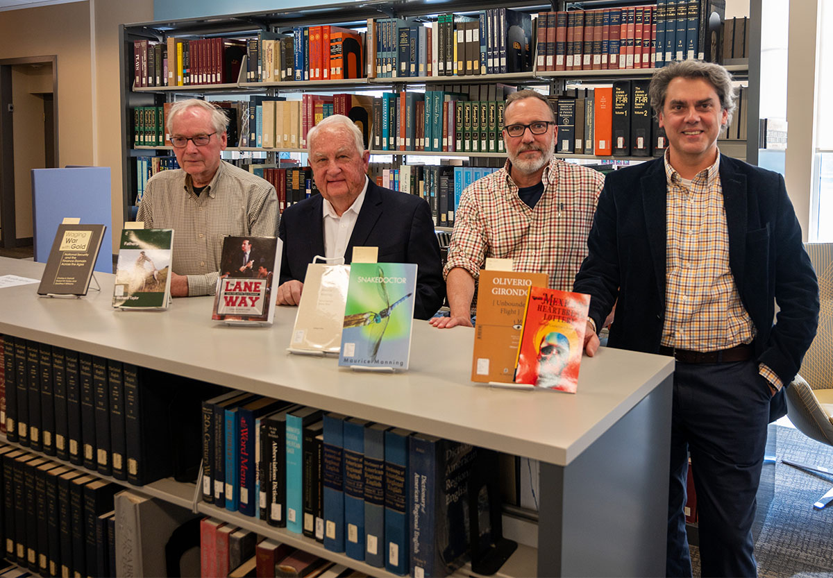 authors standing in front of books