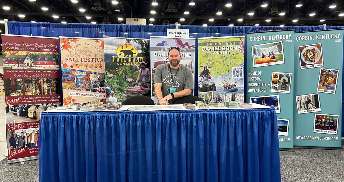 man sitting at an info table