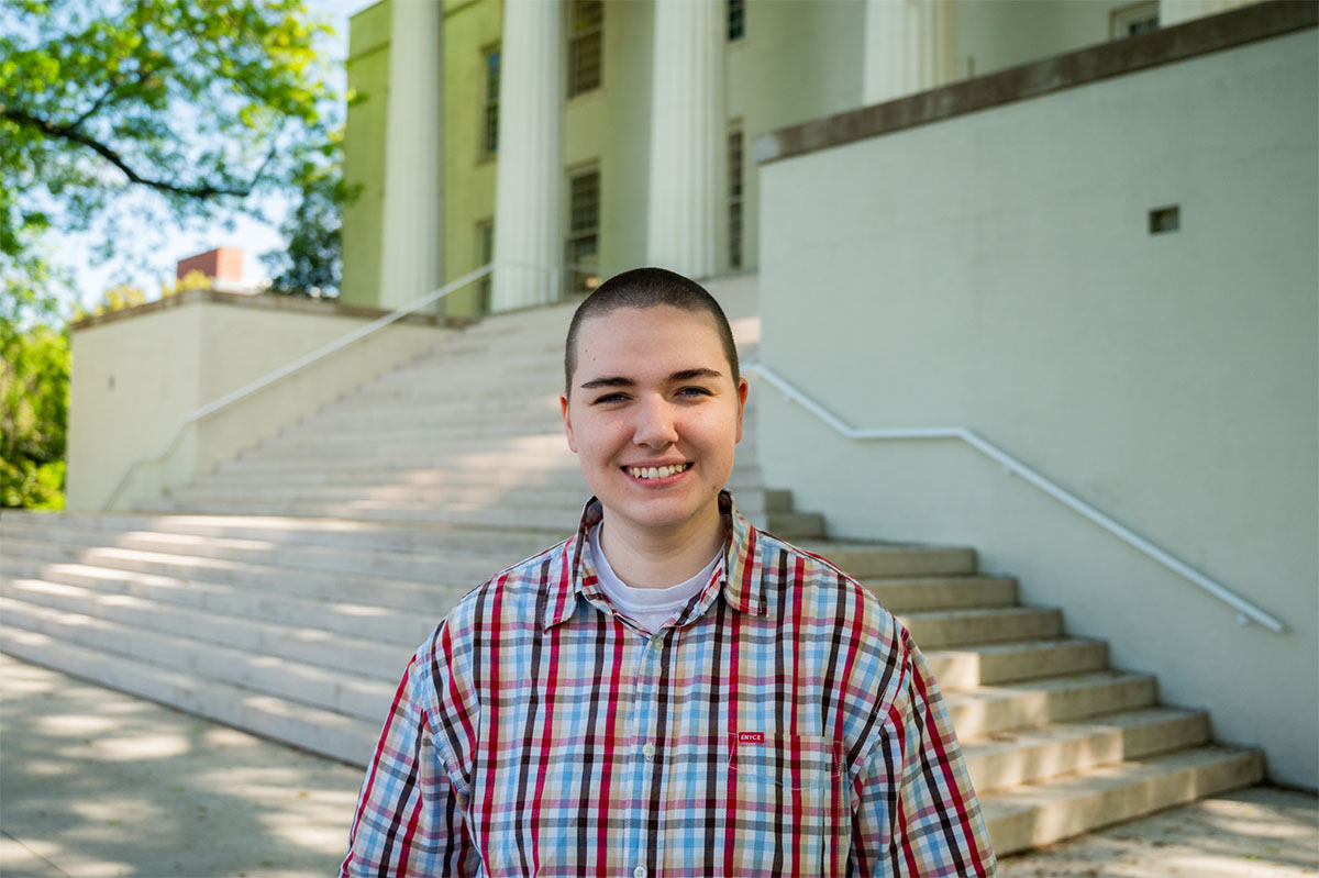 person in front of a campus building