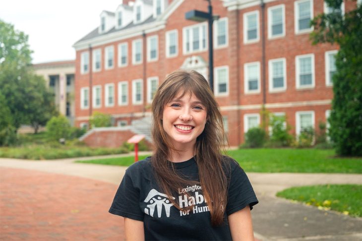 woman in front of a campus building