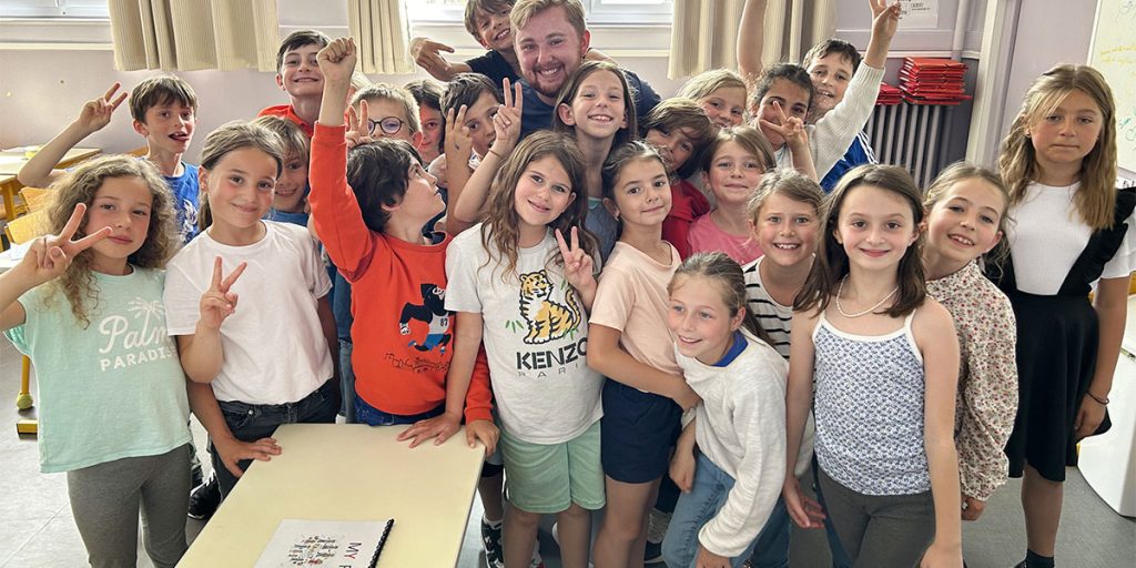 a teacher posing with students