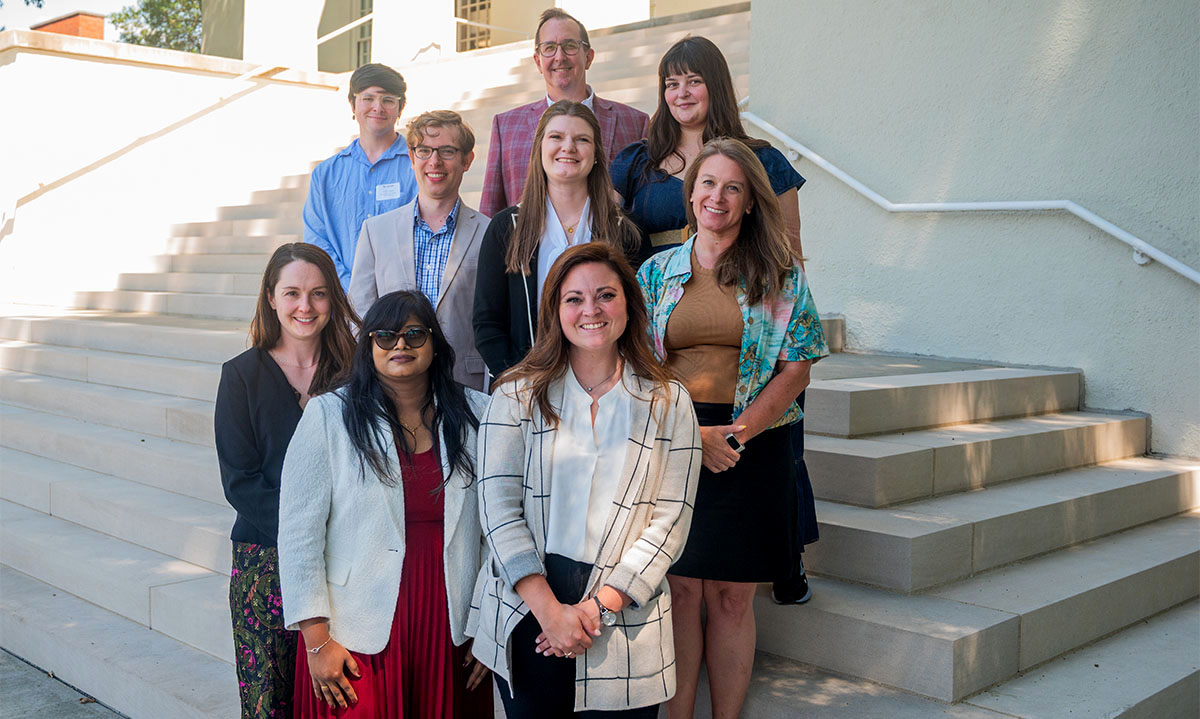 group of faculty posing on stairs
