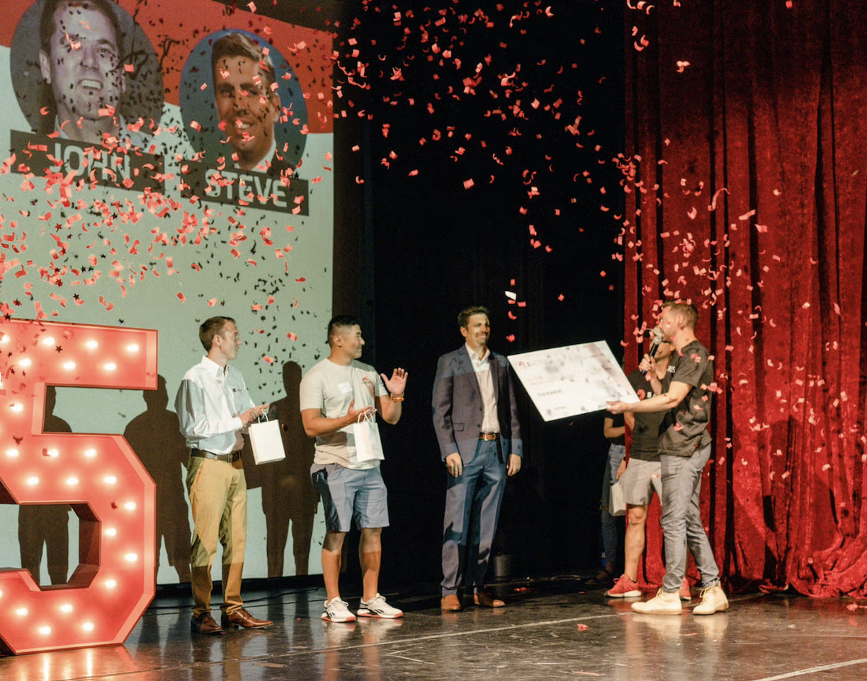 people on stage with confetti getting an award