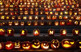 dozens of lit jack-o'-lanterns