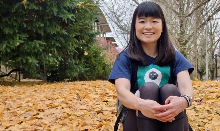 a person sitting on a leaf covered lawn