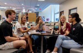 students chatting around a table