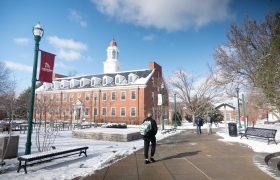 students walking across a snowy campus