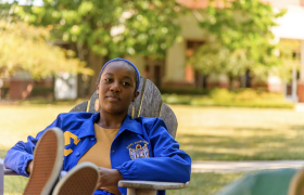 student sitting in a chair outside