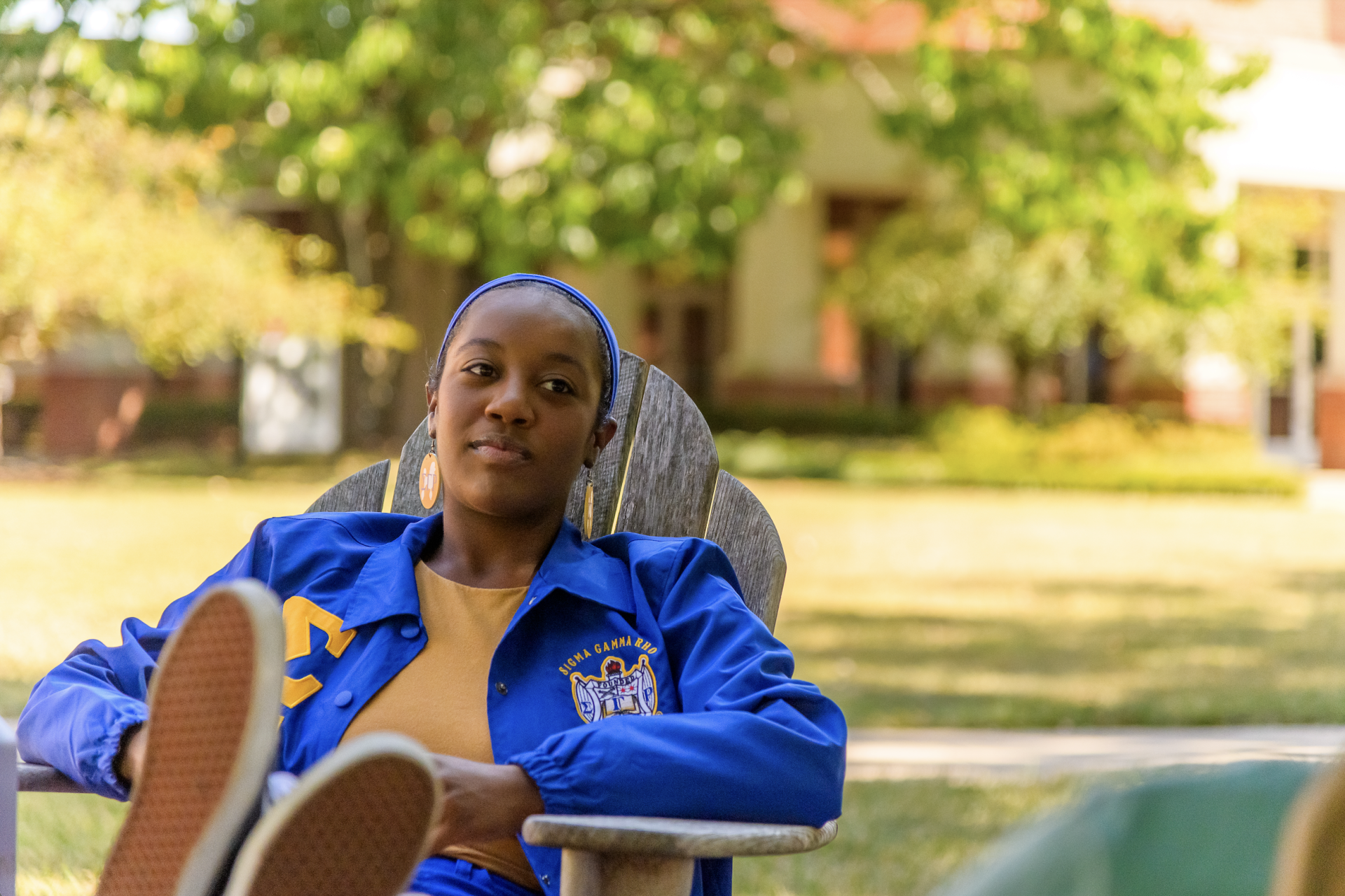 student sitting in a chair outside