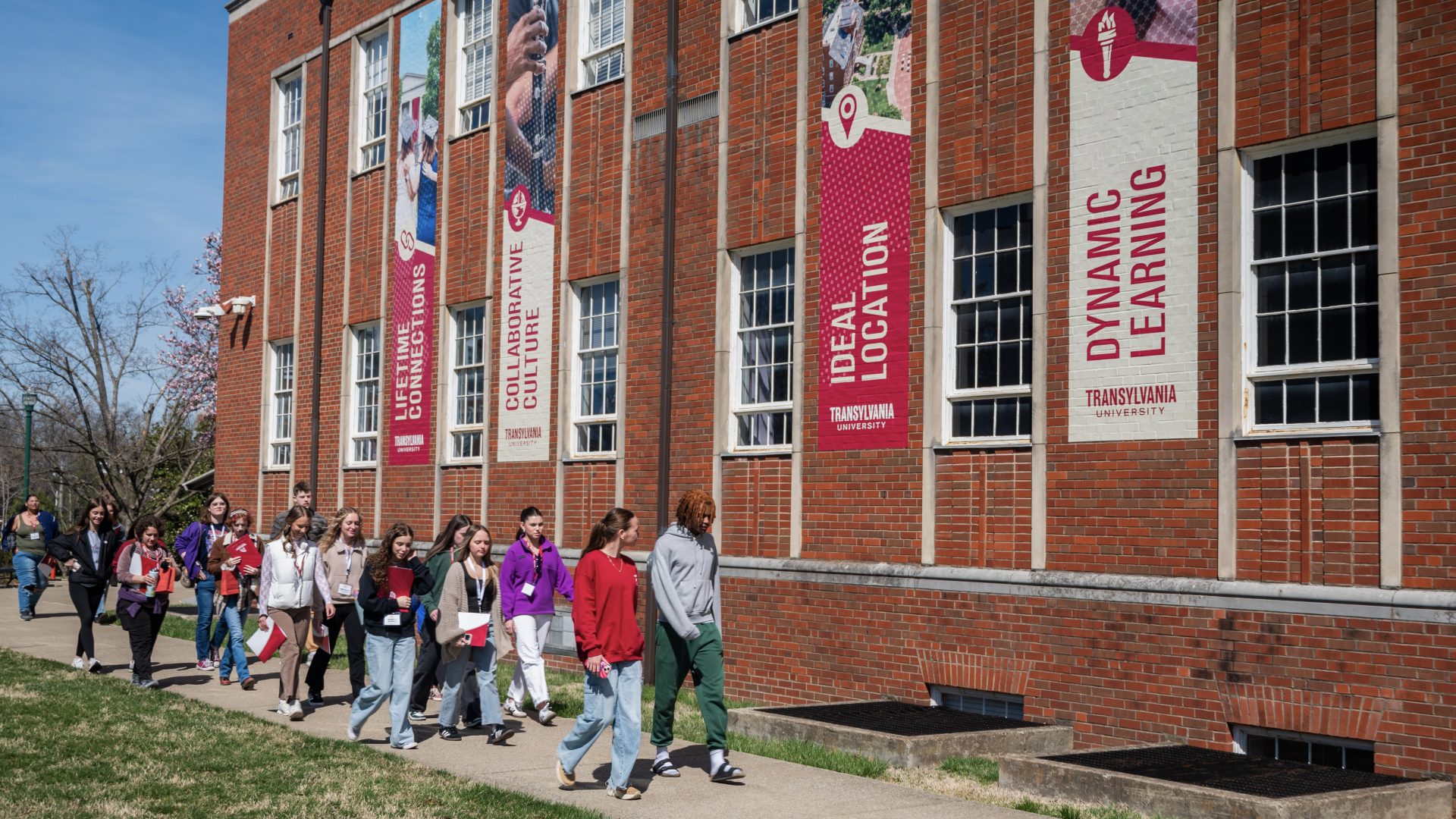 people walking in front of a campus building