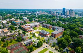 aerial shot of campus with cityscape in the background