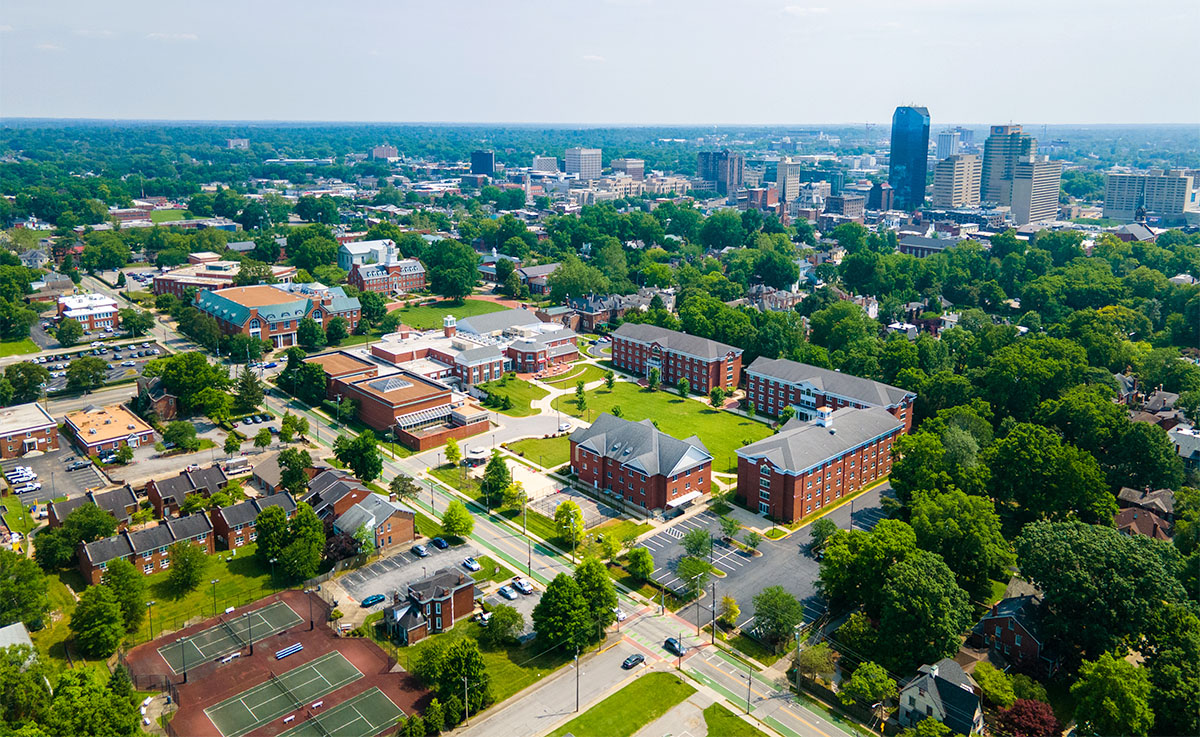 aerial shot of campus with cityscape in the background