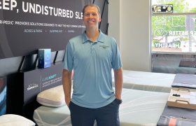 a man standing in a mattress store