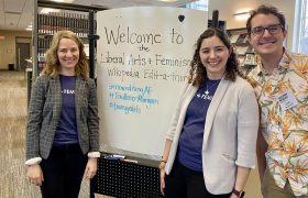 people gathered around a sign