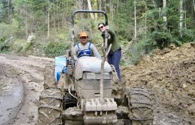 two people on a tractor