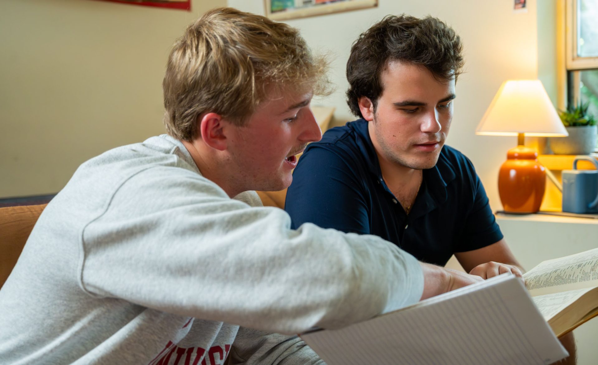 two students looking at a book