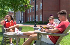 students sitting in lawn chairs
