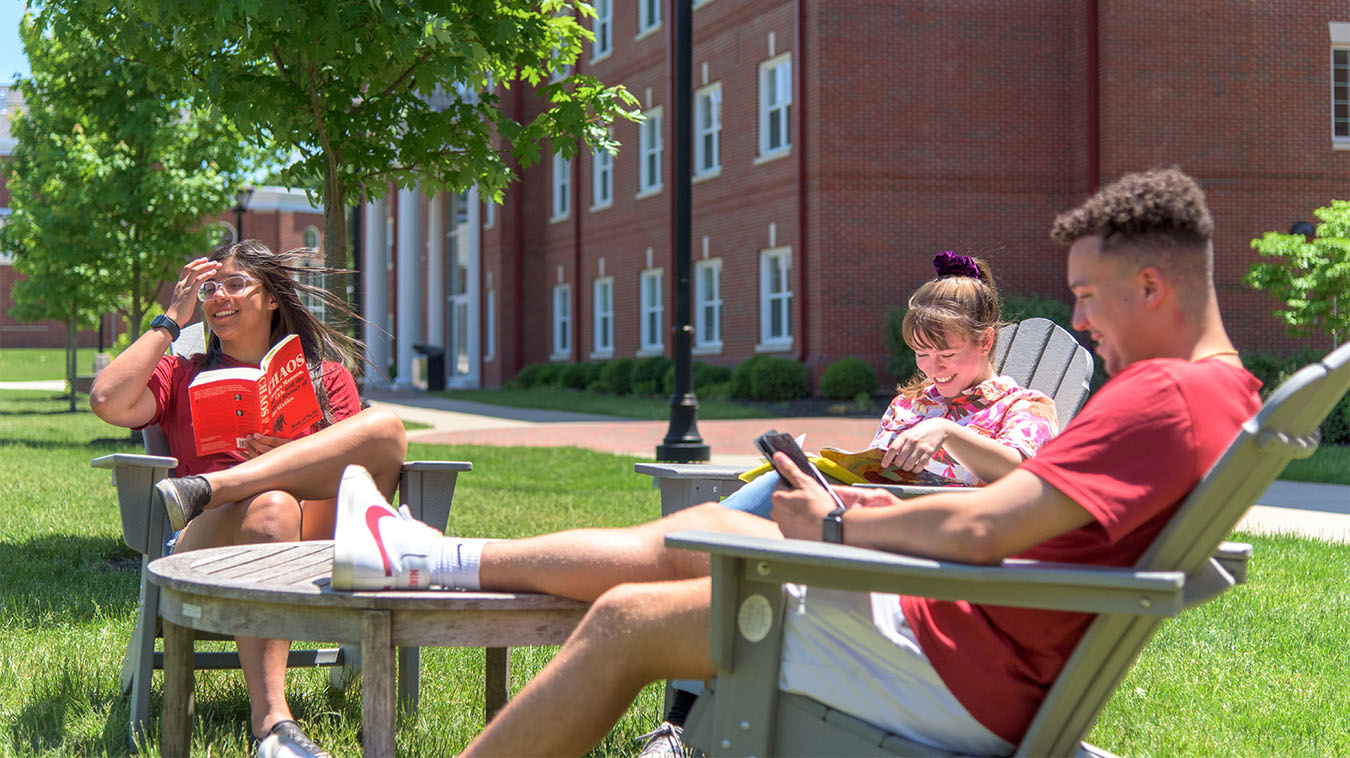 students sitting in lawn chairs
