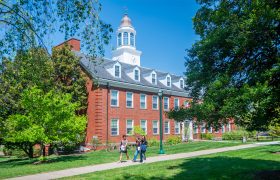 students walking in front of a campus building