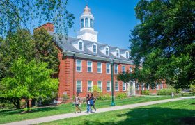 a campus building with students walking