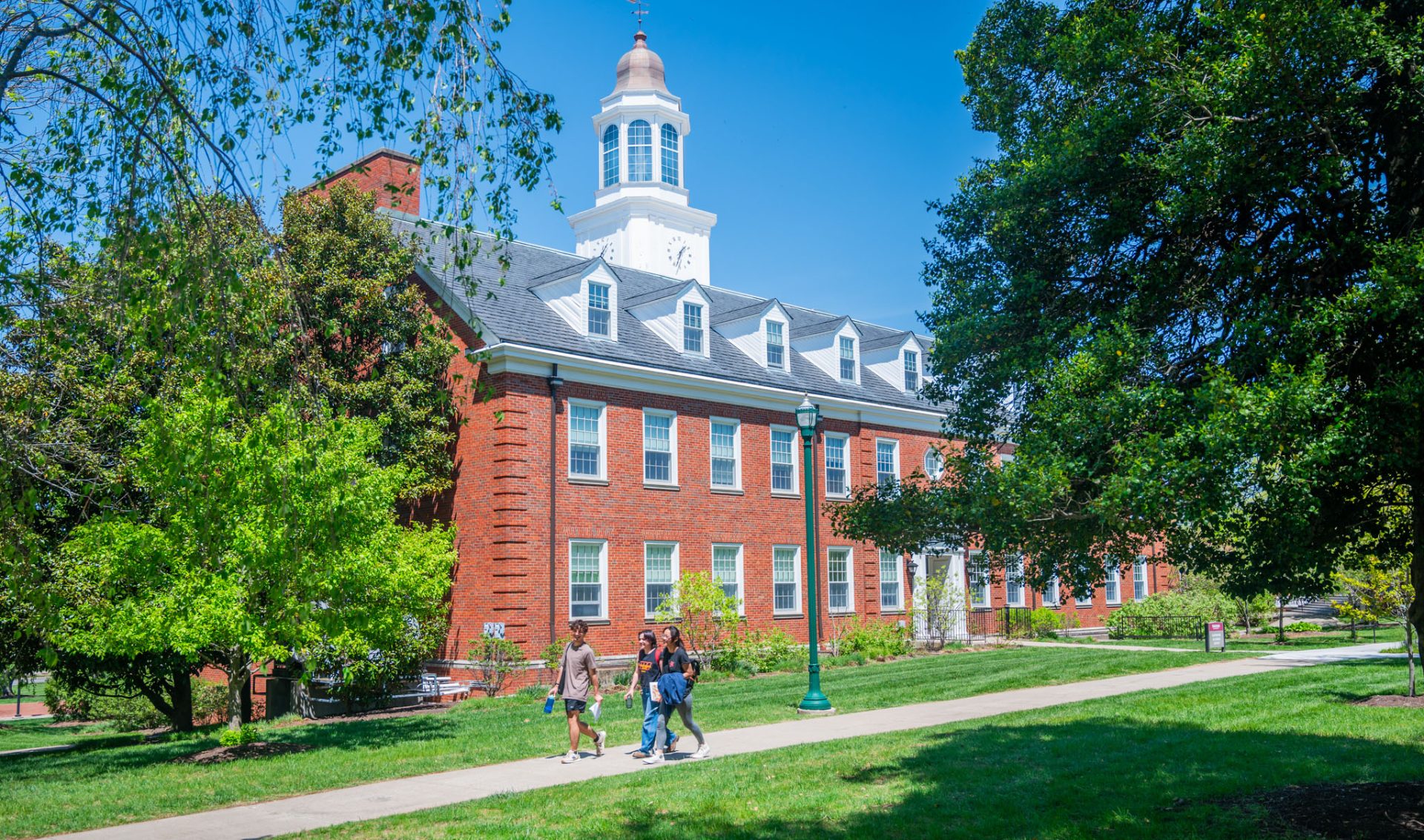 a campus building with students walking