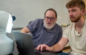 people looking at a laptop