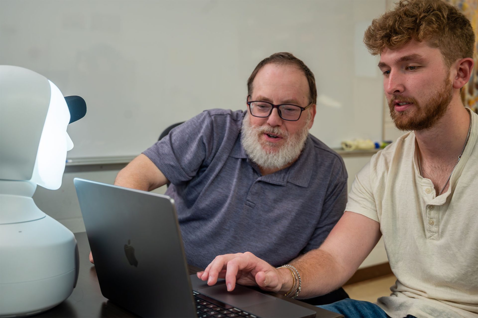 people looking at a laptop