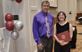 two people posing with an award