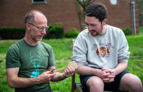 people looking at a carved spoon